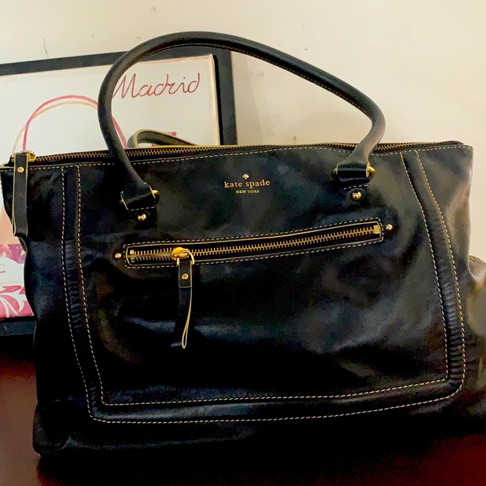 A large black Kate Spade handbag.